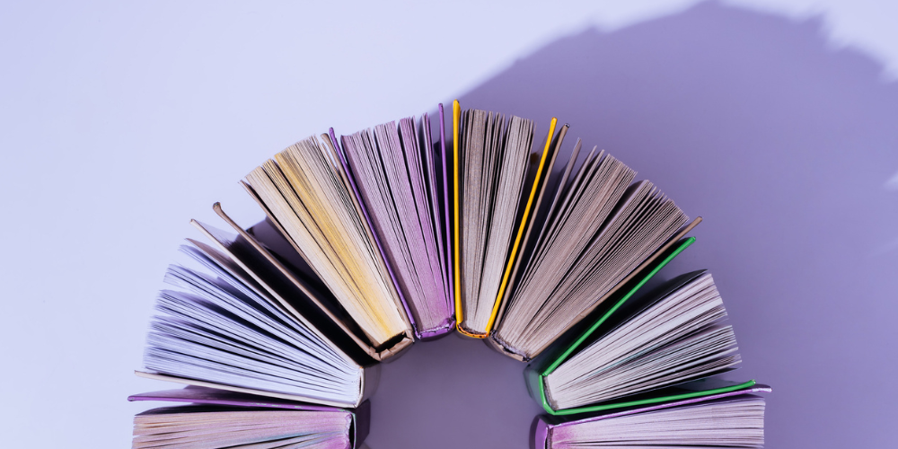 A bridge made with books on a purple background.