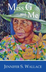 The book cover of Miss G and Me shows a painting of a Jamaican woman wearing a green floral print top and a wide-brimmed green hat.